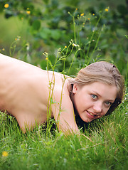 Delectable cutie with excellent straight long hair posing naked on the nature near the river.