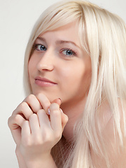 With her beautiful blue eyes, charming face, a gorgeous pair of tits, and exquisitely trimmed labia, Janelle looks alluring and irresistable on the couch.