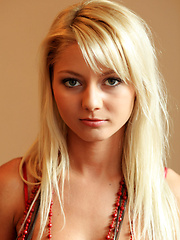 This young beautiful blonde named Grace flaunts her stunning, luscious body with gorgeous, perky tits, clean shaven pussy and shapely legs as she strips her sexy red dress in front of the camera