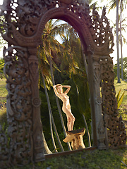 Naked girl photographer photographing her friend in the garden