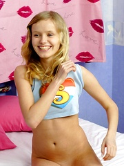 Teenage blonde hottie rubs her damp muff in her bedroom